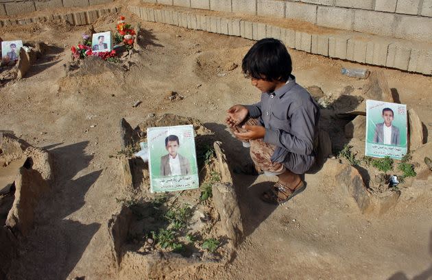 A Yemeni child at the graves of schoolboys who were killed in an August 2018 airstrike by a military coalition that included the UAE. (Photo: STRINGER via Getty Images)