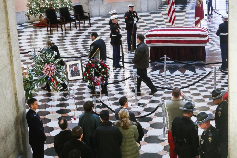 Mourners visit the casket of John Glenn as he lies in honor, Friday, Dec. 16, 2016, in Columbus, Ohio. Glenn's home state and the nation began saying goodbye to the famed astronaut who died last week at the age of 95. (AP Photo/John Minchillo)