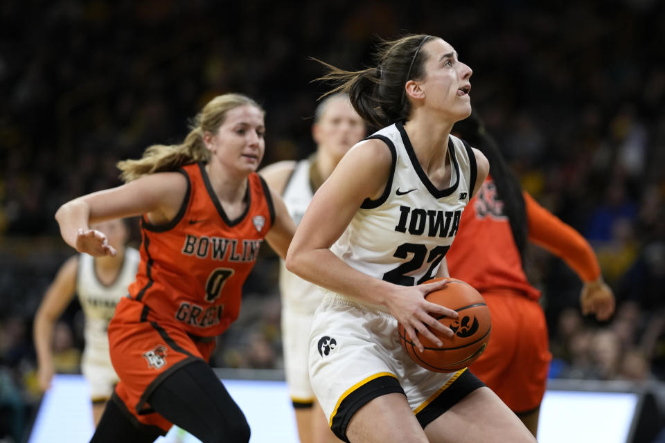 Iowa guard Caitlin Clark (22) drives to the basket past Bowling Green guard Morgan Sharps (0) during the first half of an NCAA college basketball game, Saturday, Dec. 2, 2023, in Iowa City, Iowa. (AP Photo/Charlie Neibergall)