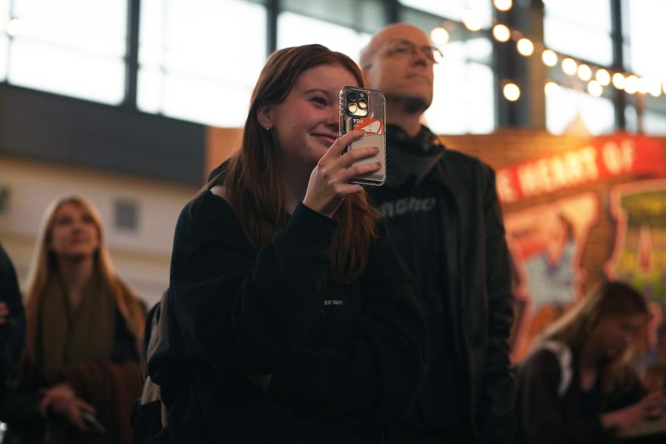 Romy VanAlmen FaceTimes friends while watching Boygenius' surprise show during South by Southwest at Austin-Bergstrom International Airport Tuesday, March 14, 2023, in Austin.