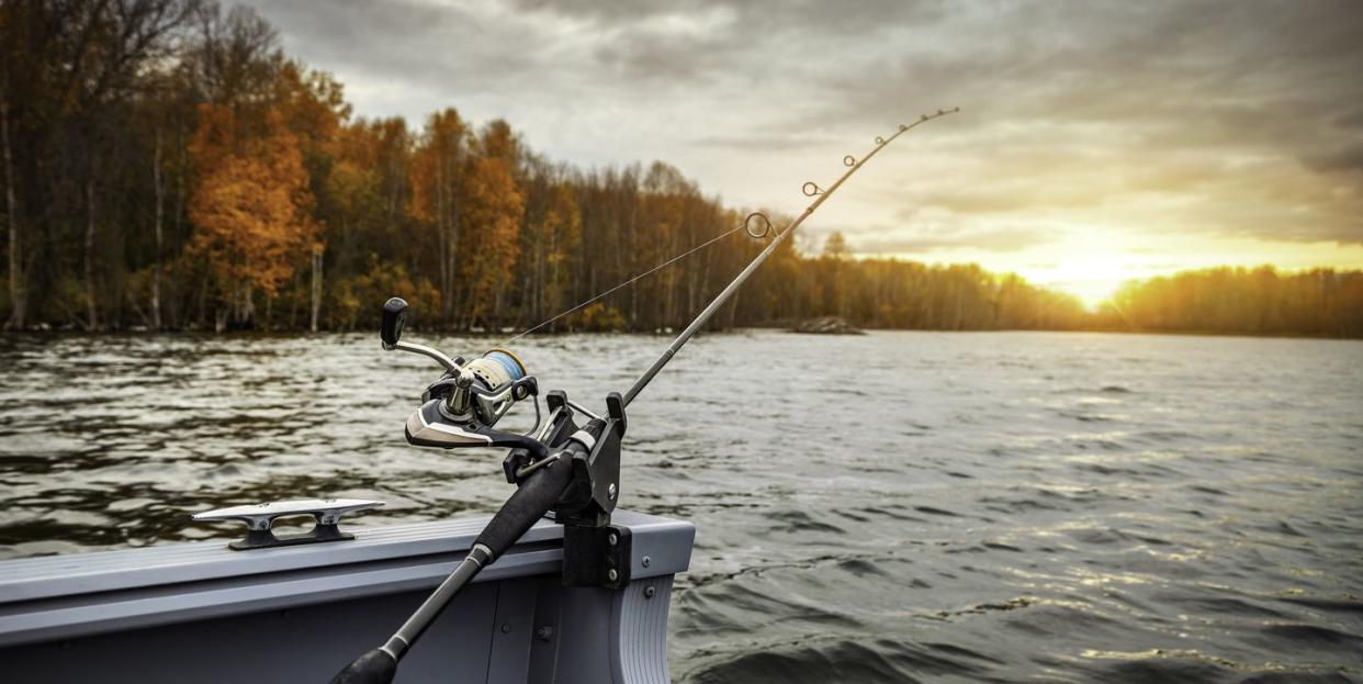 fishing rod on the boat, sunset time