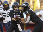 Iowa State quarterback Brock Purdy, left, hands off to Iowa State running back Kene Nwangwu during the first half of an NCAA college football game against West Virginia, Saturday, Dec. 5, 2020, in Ames, Iowa. (AP Photo/Matthew Putney)