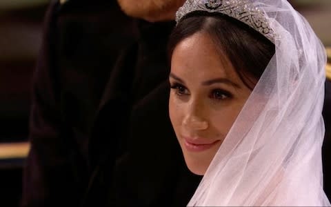 Meghan Markle listens during her wedding ceremony  - Credit: Sky News/AP