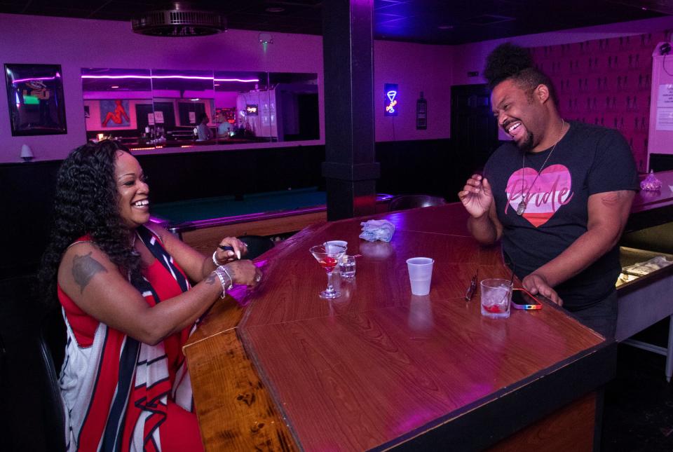 Rachel Smallman, left, and Beyonce Brito have a laugh at Herz lesbian bar in Mobile, Alabama.