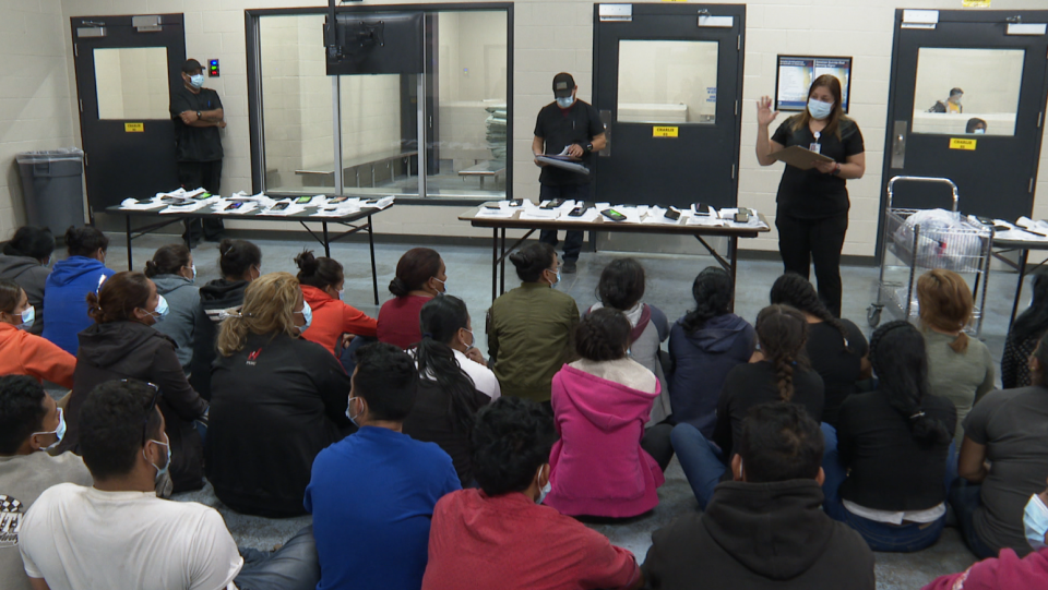 Migrants prepare to receive their COVID-19 shots at a border facility in McAllen, Texas, on Tuesday, May 17, 2022. / Credit: Nicole Sganga / CBS News