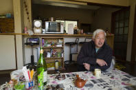 Naoto Matsumura speaks during an interview with The Associated Press at his home in Tomioka town, Fukushima prefecture, northeastern Japan, Sunday, Feb. 28, 2021. About 10 kilometers (6 miles) south of the wrecked Fukushima Dai-ichi nuclear power plant, rice farmer Matsumura defied a government evacuation order and stayed on his farm to protect his land the cattle abandoned by neighbors a decade ago. (AP Photo/Hiro Komae)