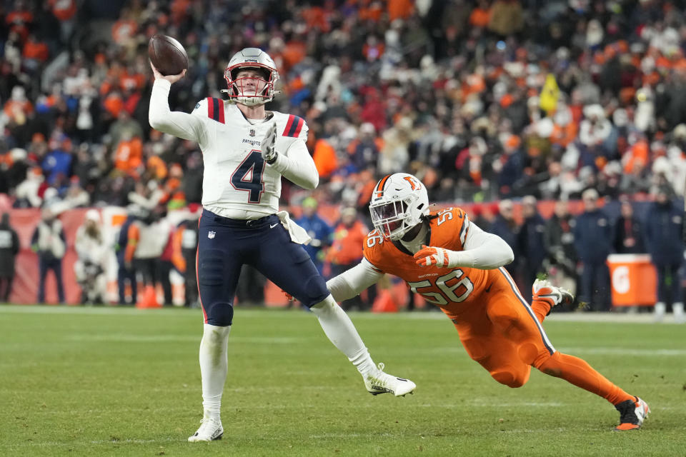 New England Patriots quarterback Bailey Zappe (4) throws an 11-yard touchdown pass to tight end Mike Gesicki during the second half of an NFL football game against the Denver Broncos, Sunday, Dec. 24, 2023, in Denver. (AP Photo/David Zalubowski)