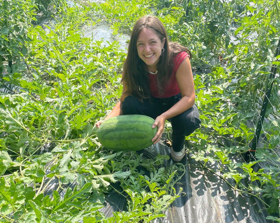 Savannah Miles is pictured with a watermelon grown at In the Pines, a farm she and her boyfriend own in Ballplay.