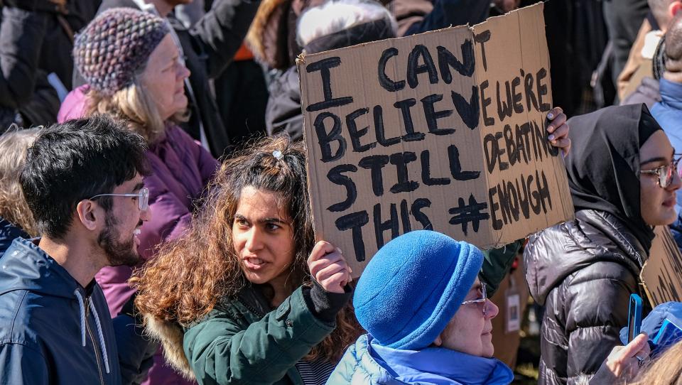 A woman holds a hand-made sign at the gun violence prevention rally at the Capitol Wednesday, Mar. 15, 2023,