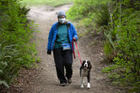 KENMORE, WA - MAY 05: Lynette Fisher-Charles and her dog Gracie, a two-year-old springer spaniel, go for a hike in Saint Edward State Park on May 5, 2020 in Kenmore, Washington. The first phase to reopen the state begins today easing some restrictions including opening some parks, that were put in place during Governor Jay Inslees Stay Home, Stay Healthy order last March to help reduce the spread of COVID-19. Kenmore, WA is located northeast of Seattle. (Photo by Karen Ducey/Getty Images)