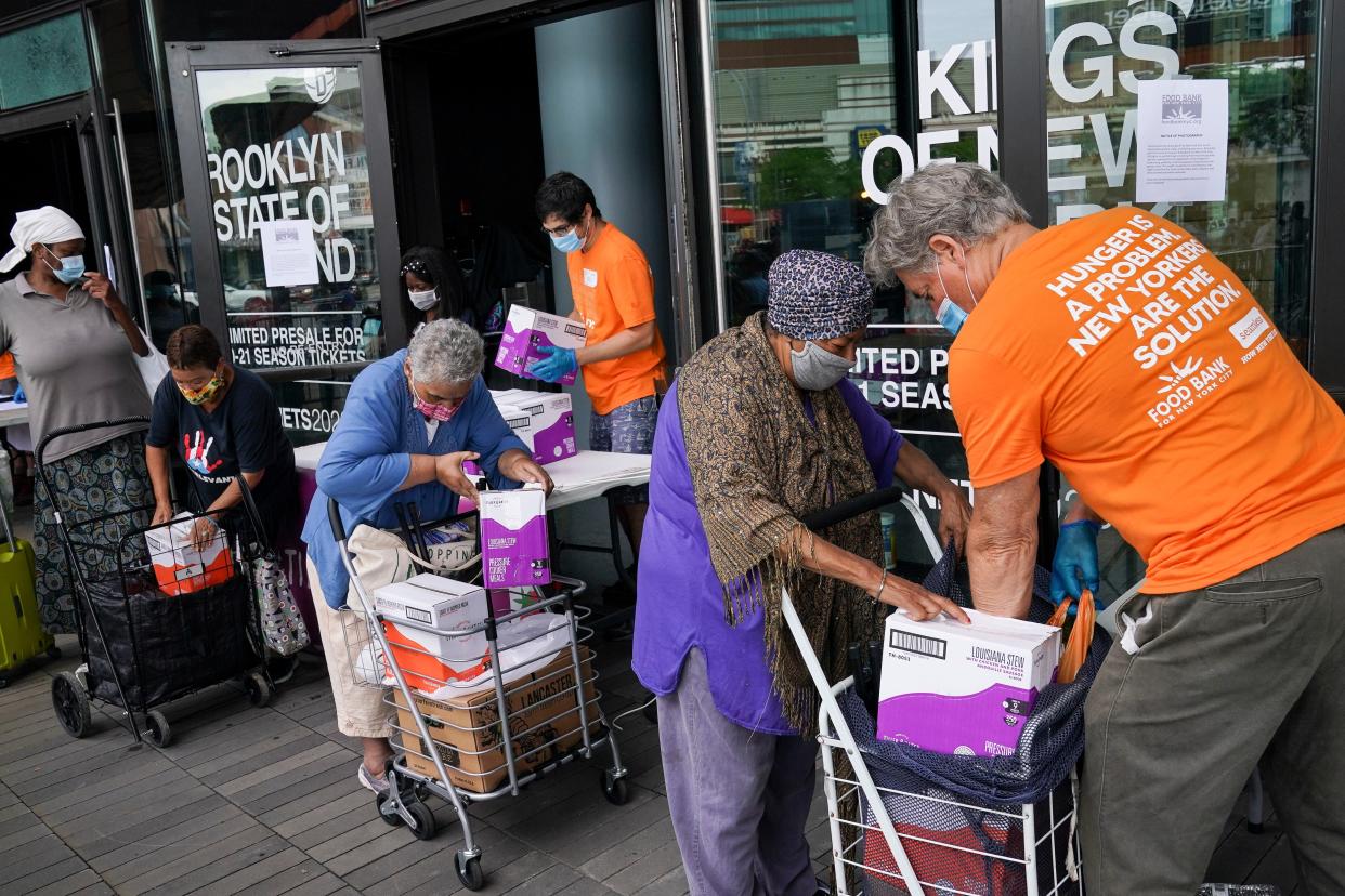 The elderly collect fresh produce and shelf-stable pantry items outside Barclays Center as Food Bank For New York City provides assistance to those in need due to the COVID-19 pandemic, Thursday, Sept. 10, 2020, in New York. 