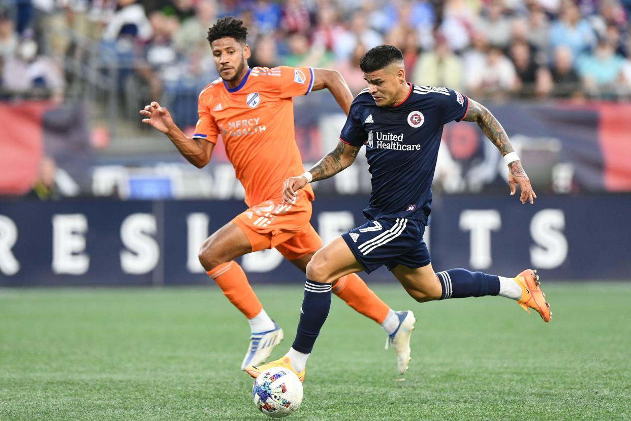 Jul 3, 2022; Foxborough, Massachusetts, USA; New England Revolution forward Gustavo Bou (7) controls the ball in front of FC Cincinnati defender Ian Murphy (32) during the first half at Gillette Stadium.