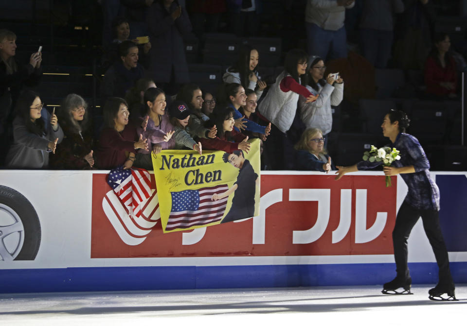 Nathan Chen high fives fans after the medal ceremony at Skate America, Saturday, Oct. 20, 2018, in Everett, Wash. (Olivia Vanni/The Herald via AP)