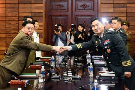 South Korean Major General Kim Do-gyun shakes hands with North Korean Lieutenant General An Ik-san during their high-level miilitary talk at the northern side of the truce village of Panmunjom, in North Korea, June 14, 2018. Yonhap via REUTERS