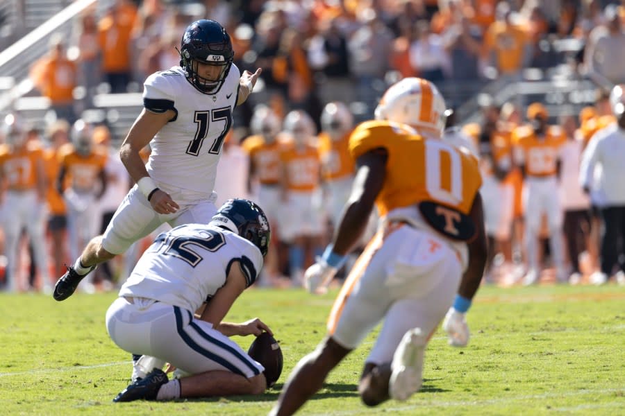 UConn place-kicker Noe Ruelas (17) kicks a field goal as punter George Caratan (42) holds during the first half of an NCAA college football game against Tennessee, Saturday, Nov. 4, 2023, in Knoxville, Tenn. (AP Photo/Wade Payne)