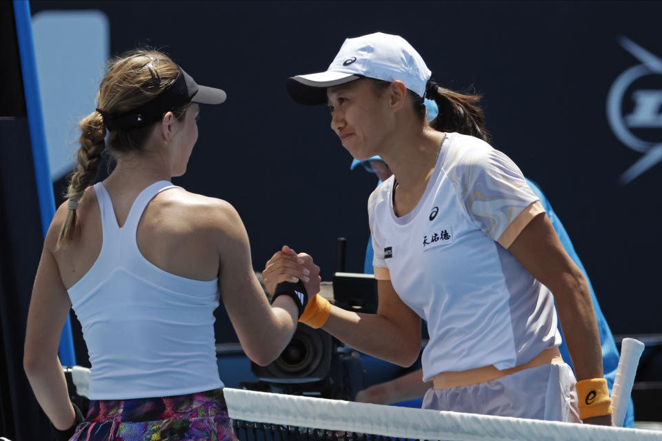 Zhang Shuai, right, of China is congratulated by Katie Volynets of the U.S. following their third round match at the Australian Open tennis championship in Melbourne, Australia, Saturday, Jan. 21, 2023. (AP Photo/Asanka Brendon Ratnayake)