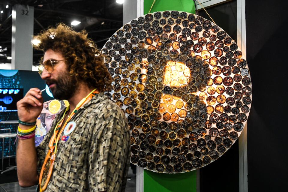 A man poses next to a Bitcoin logo during the Bitcoin 2022 Conference at the Miami Beach Convention Center in Miami Beach, Florida, on April 7, 2022. (Photo by CHANDAN KHANNA/AFP via Getty Images)