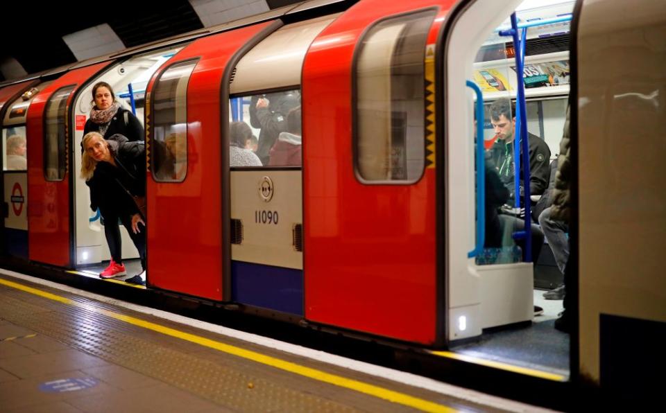 Commuters travel in the morning rush hour on a Victoria line Tube train. (Photo by Tolga Akmen/AFP via Getty Images)