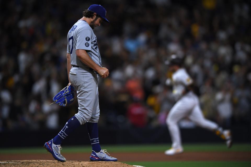 Los Angeles Dodgers starting pitcher Trevor Bauer (left) looks on from the mound after a home run by San Diego Padres catcher Victor Caratini (right) during the seventh inning at Petco Park.