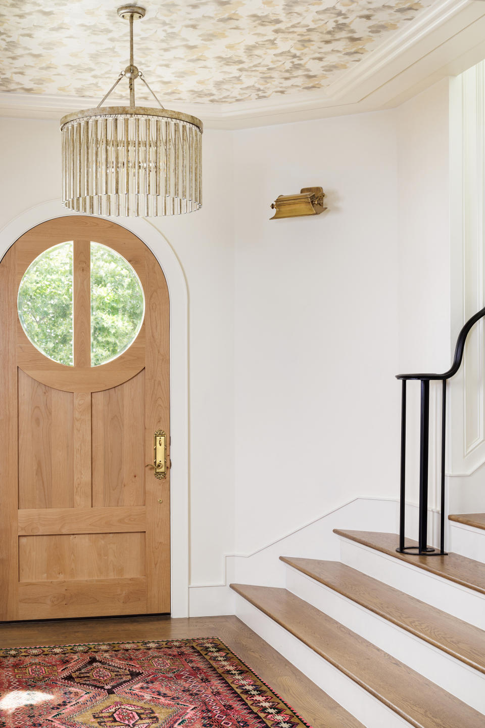 A wooden front door in an entryway