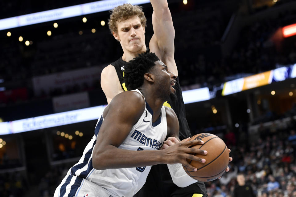 Memphis Grizzlies forward Jaren Jackson Jr. (13) handles the ball against Utah Jazz forward Lauri Markkanen in the second half of an NBA basketball game, Sunday, Jan. 8, 2023, in Memphis, Tenn. (AP Photo/Brandon Dill)