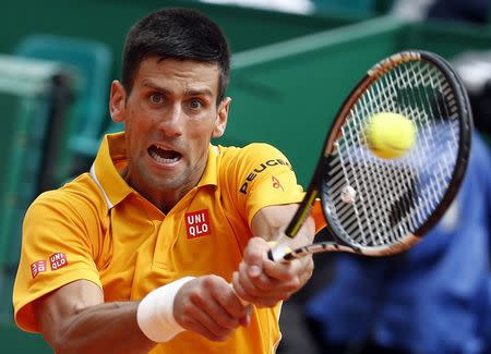 Novak Djokovic of Serbia returns the ball to Marin Cilic of Croatia during their quarter-final match at the Monte Carlo Masters in Monaco April 17, 2015. REUTERS/Eric Gaillard