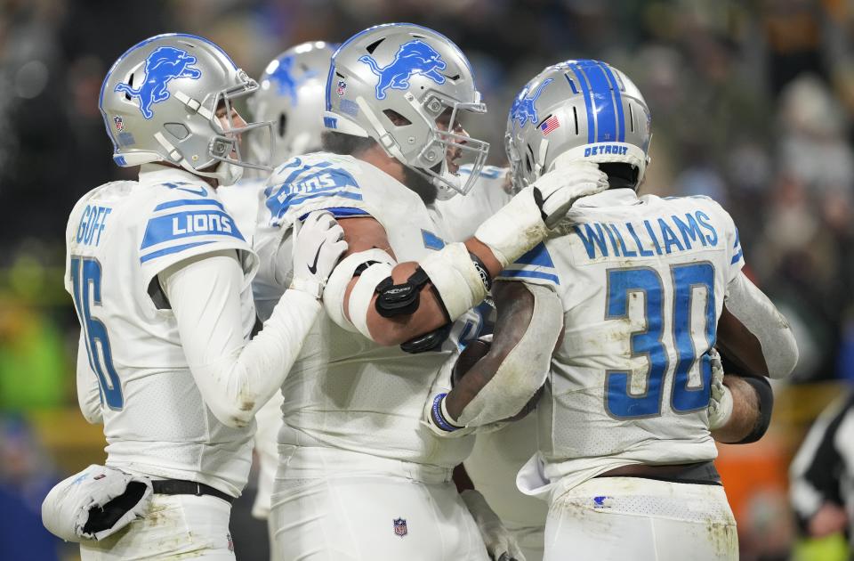 Lions running back Jamaal Williams celebrates with teammates after scoring a touchdown during the fourth quarter of the Lions' 20-16 win over the Packers on Sunday, Jan. 8, 2023, in Green Bay, Wisconsin.