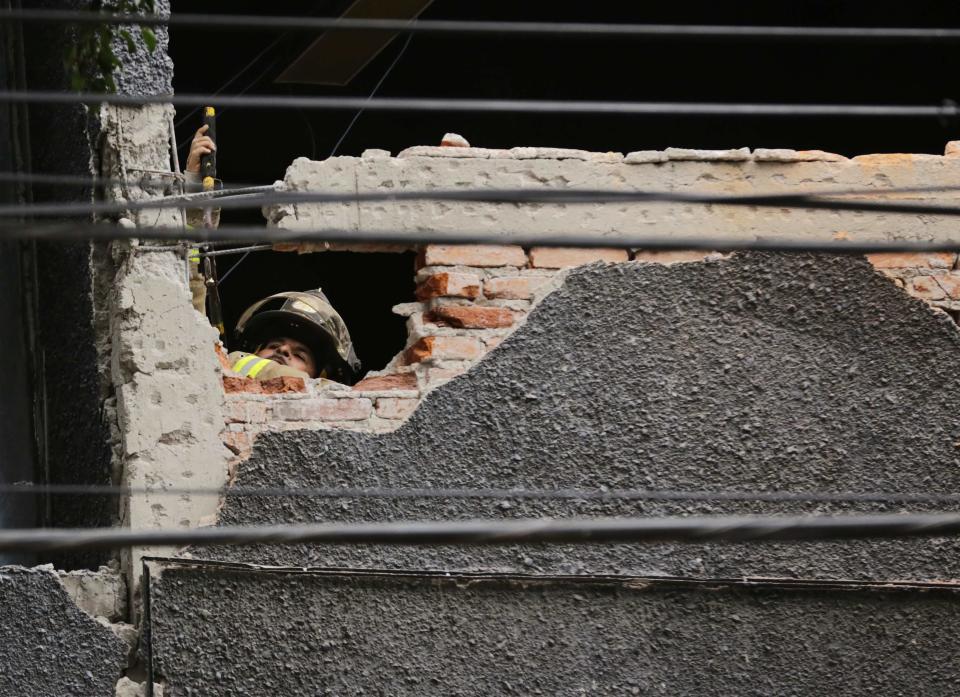 A firefighter works to demolish the damaged wall of a building after a 6.4-magnitude earthquake in Mexico City May 8, 2014. A 6.4 magnitude earthquake shook Mexico City on Thursday, rattling buildings and prompting office evacuations, but there were no immediate reports of damage.The U.S. Geological Survey put the quake epicenter in the western Mexican state of Guerrero at a depth of 14.9 miles (23.9 km) just inland from the Pacific Coast. No tsunami alert was triggered.The USGS initially said the quake was of 6.8 magnitude, and had reported it was much shallower. A quake of that magnitude can cause damage to buildings, especially poorly designed structures. (REUTERS/Henry Romero)