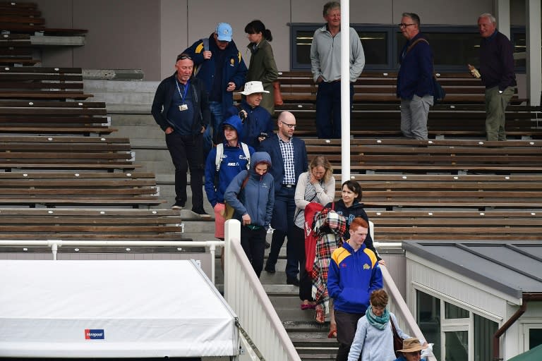 Members of the public are evacuated from the main stand after a fire alarm during day three of the first test between New Zealand and South Africa in Dunedin