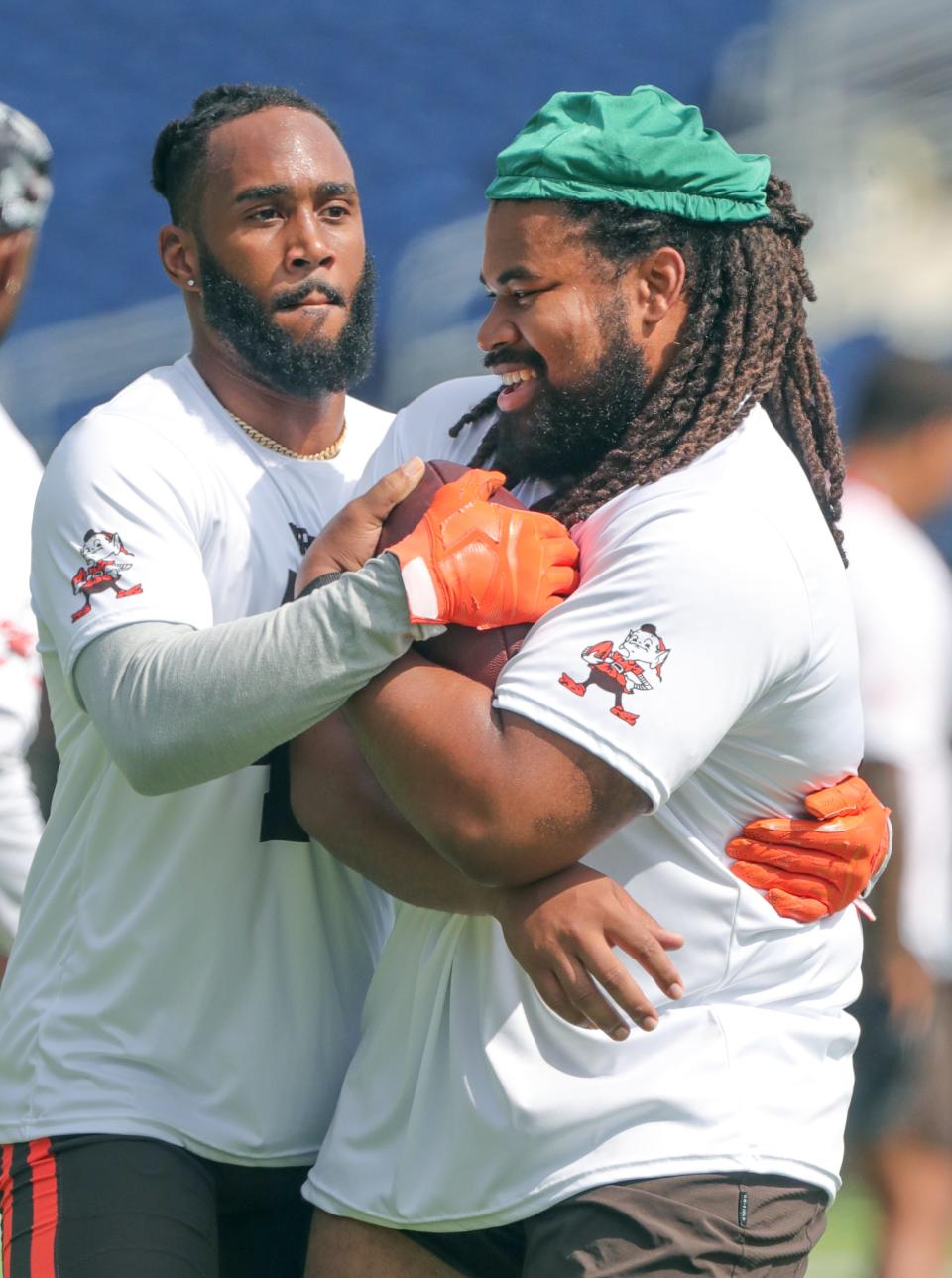 Cleveland Browns defenders John Johnson III, left, and Sheldon Day wrestle for possession of the ball during minicamp drills on Wednesday, June 15, 2022 in Canton, Ohio, at Tom Benson Hall of Fame Stadium.