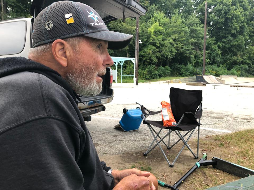 Mark Osborne watches skate park riders near his car at O'Brien Park in South Bend on Sept. 8. 2023.