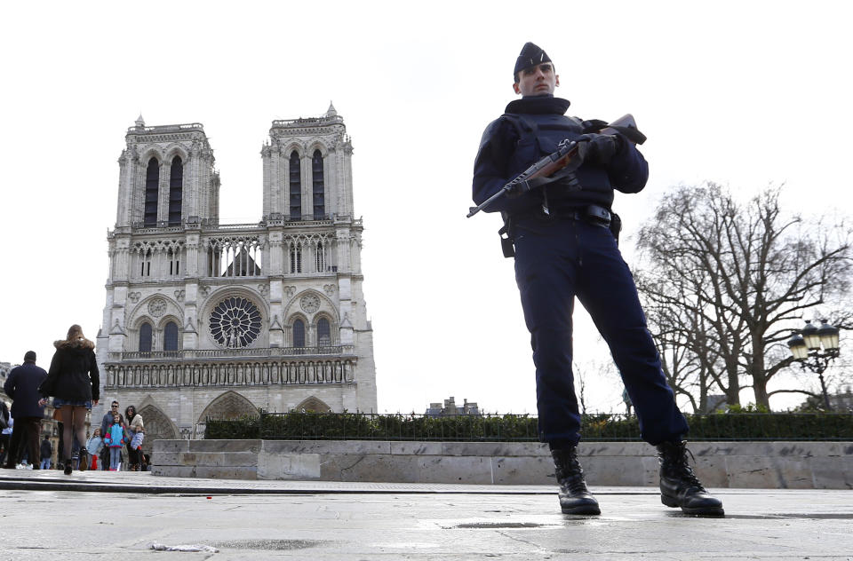 - FILE - In this March 27, 2016 file photo, a French police officer stands guards as worshipers arrive for the Easter mass at Notre Dame Cathedral, in Paris. Before it was ravaged by fire, Notre Dame Cathedral was the target of a bungled terrorist plot by two French women who pledged allegiance to the Islamic State group. They're going on trial Monday Sept.23 2019 in a special Paris court, for attempting to explode a vehicle laden with fuel-doused gas canisters in the shadow of the medieval monument in 2016. (AP Photo/Francois Mori, File)