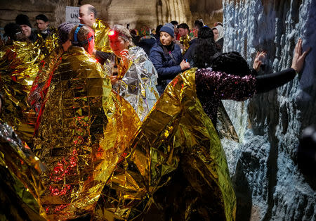 Participants rest after the "Milestii Mici Wine Run 2019" race, at a distance of 10 km in the world's largest wine cellars in Milestii Mici, Moldova January 20, 2019. Picture taken January 20, 2019. REUTERS/Gleb Garanich