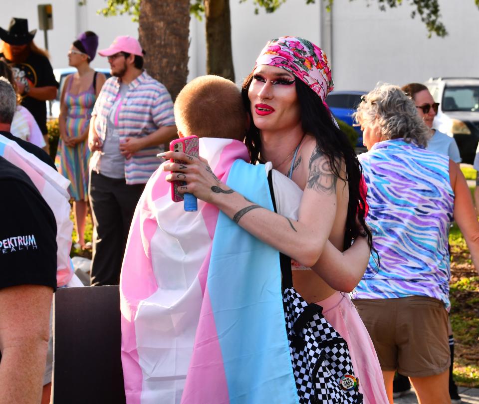 Sapphirah Jade hugs Sebastian Cook. About 250 people gathered at Eau Gallie Square Friday evening to celebrate International Transgender Day of Visibility. The event was organized by Spektrum, a nonprofit LGBTQ healthcare provider with clinics in Orlando and Melbourne.