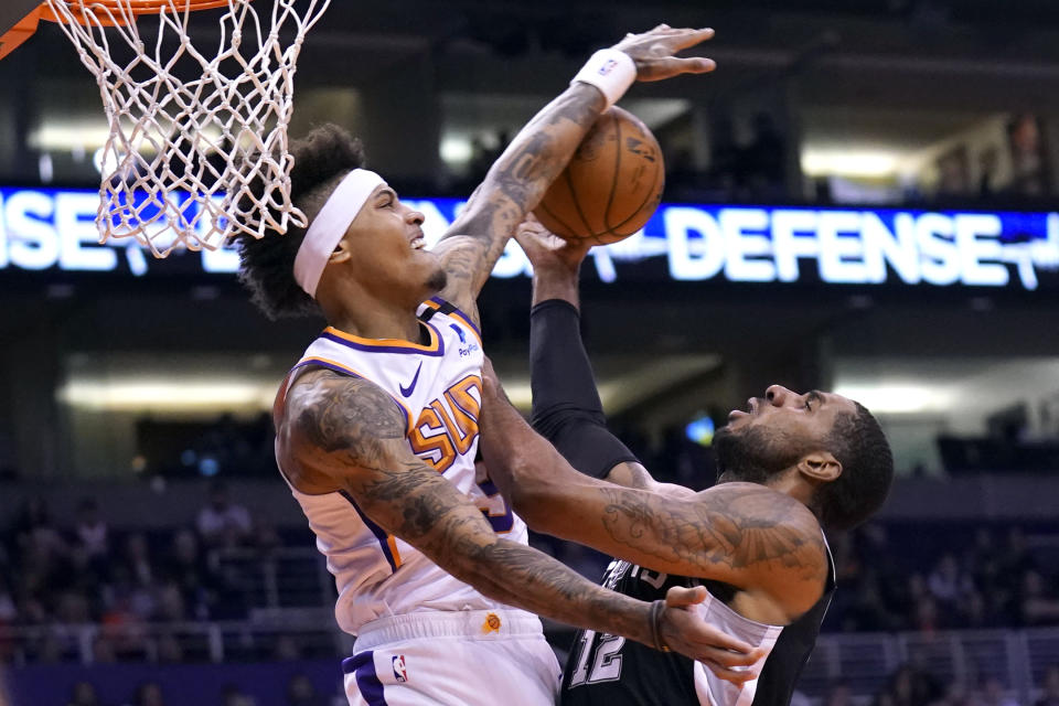 Phoenix Suns forward Kelly Oubre Jr. (3) blocks the shot on San Antonio Spurs center LaMarcus Aldridge during the first half of an NBA basketball game Monday, Jan. 20, 2020, in Phoenix. (AP Photo/Rick Scuteri)