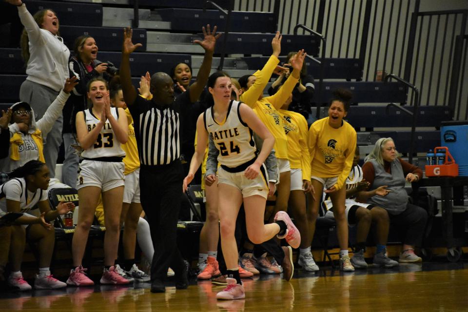 Battle forward KJ Johnson (24) runs back down the floor as her teammates celebrate her fifth 3-point make of the night during the Spartans' win over Rock Bridge on Dec. 6, 2022, at Battle High School in Columbia, Mo.