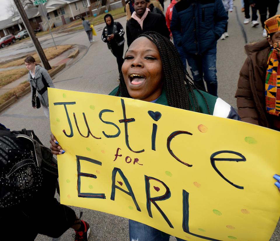 Chatara Moore, sister of Earl Moore Jr., walks down Martin Luther King Jr. Dr. during the Unity March in Springfield Monday  Jan. 16, 2023.