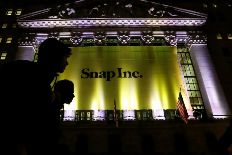 A Banner for Snap Inc. hangs on the facade of the the New York Stock Exchange (NYSE) on the eve of the company's IPO in New York, U.S., March 1, 2017. REUTERS/Brendan McDermid