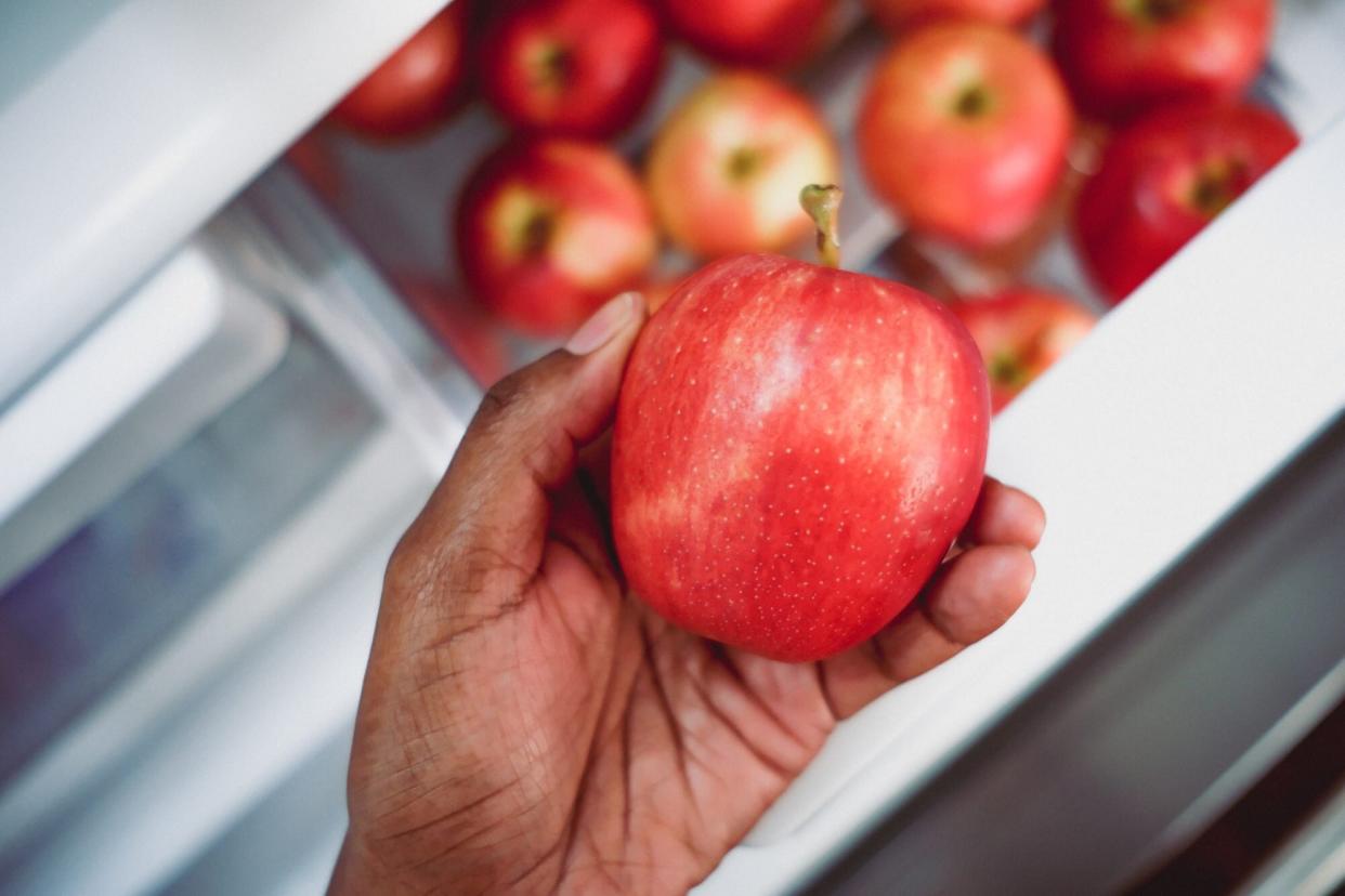 Woman Gets Apple from Refrigerator