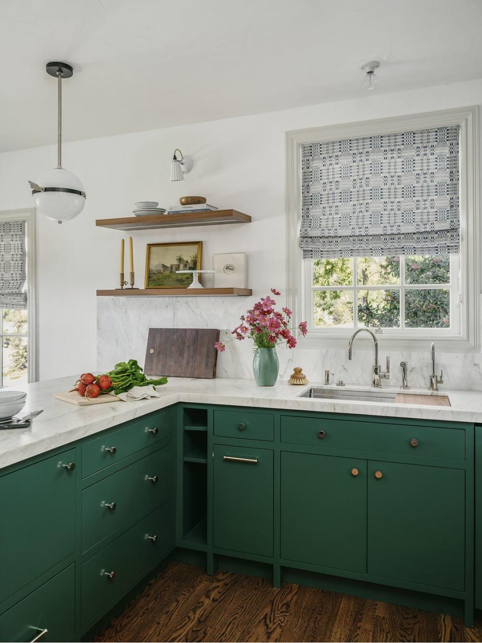 a kitchen with green cabinets