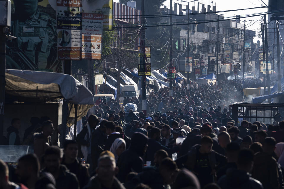 Palestinians crowd at a street market in Rafah, Gaza Strip, Wednesday, Feb. 21, 2024. (AP Photo/Fatima Shbair)