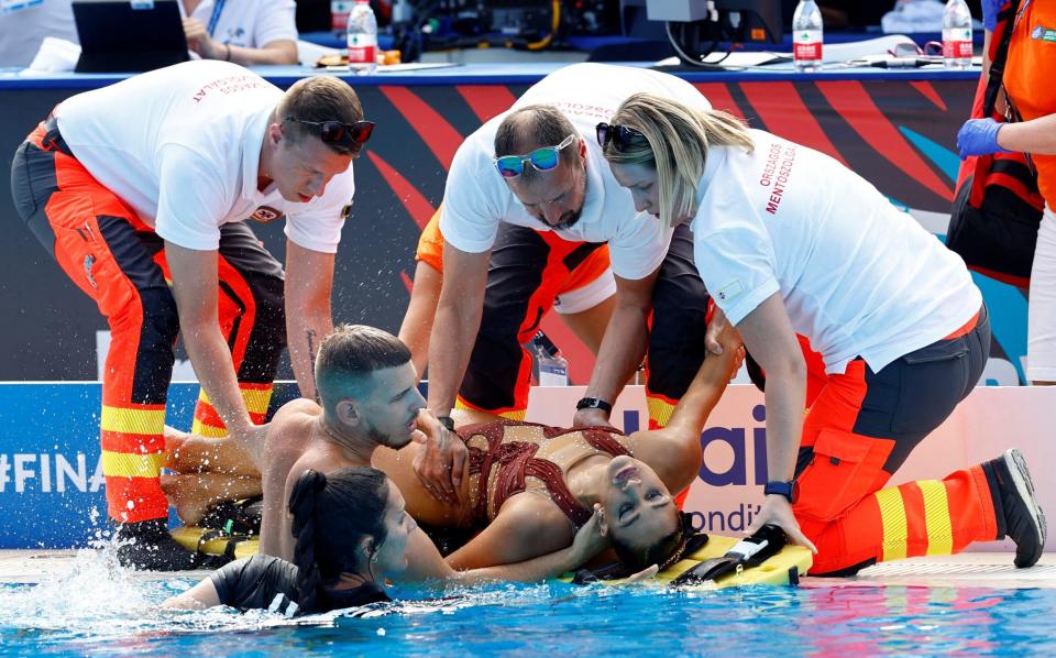 Alvarez is attended to by medical staff - Swimmer Anita Alvarez banned from competing in team event due to health fears after drowning scare - REUTERS