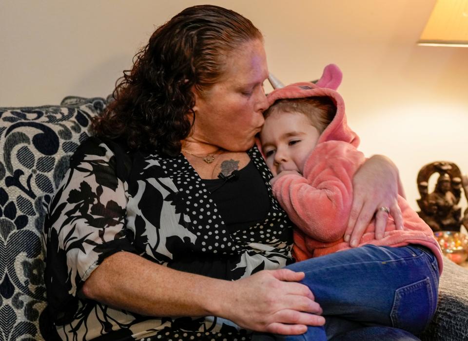 Jami Wallace gives a kiss to her daughter, Kyla Rose, 4 in their East Liverpool home Wednesday, January 24, 2024. Wallace moved from East Palestine after a train derailment a year ago that leaked dangerous chemicals into the soil and has been advocating for residential air testing and health coverage for East Palestine residents.