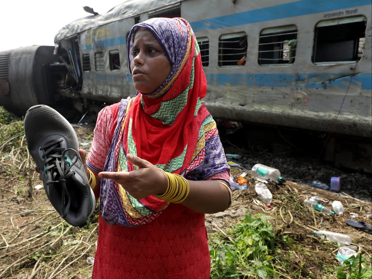 Tammanna Begum shows a shoe of her missing son (EPA)