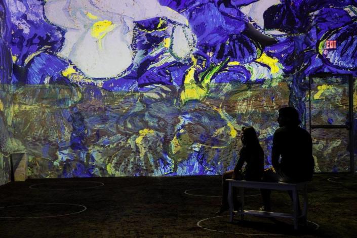 People watch the Immersive Van Gogh Exhibit in Charlotte that opened in June and ended in early January after three extensions because of its popularity.