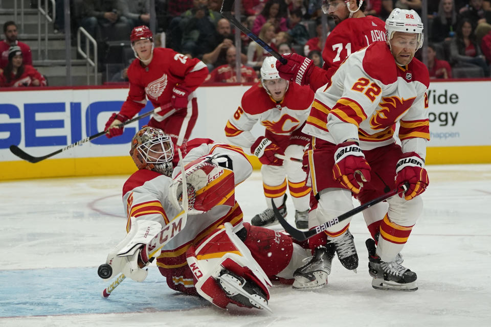 Calgary Flames goaltender Jacob Markstrom (25) deflects a Detroit Red Wings shot in the second period of an NHL hockey game Thursday, Oct. 21, 2021, in Detroit. (AP Photo/Paul Sancya)