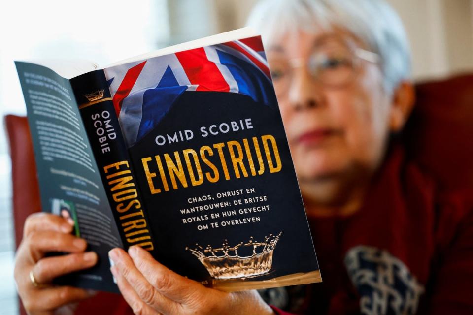 A woman reads a Dutch translation of ‘Endgame’ by Omid Scobie, a book about the British royal family, in Beuningen, Netherlands (Reuters)