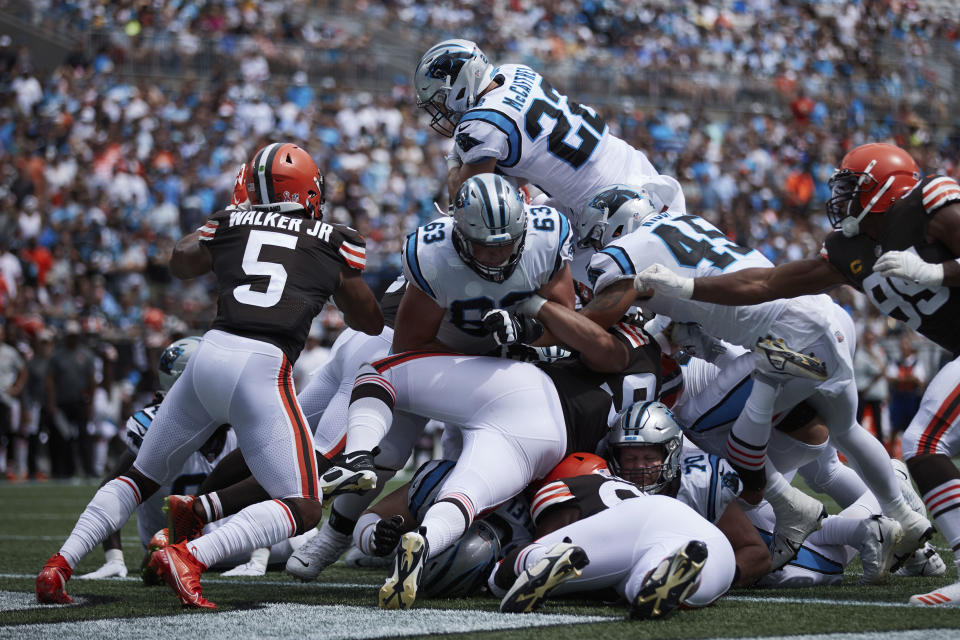 Carolina Panthers running back Christian McCaffrey (22) leaps over the pile to score a touchdown during an NFL football game against the Cleveland Browns, Sunday, Sep. 11, 2022, in Charlotte, N.C. (AP Photo/Brian Westerholt)