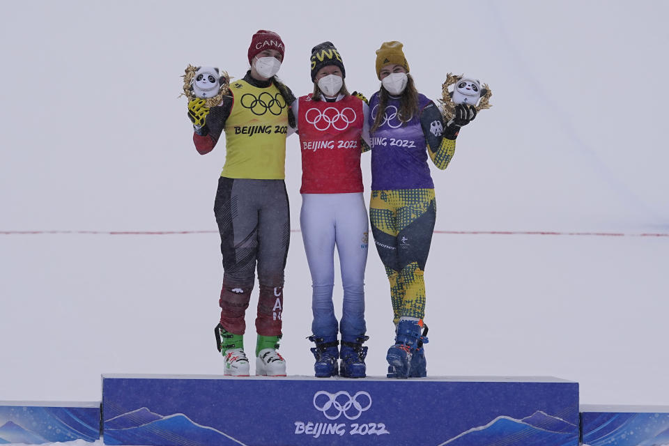 From left silver medal winner Canada's Marielle Thompson, gold medal winner Sweden's Sandra Naeslund and bronze medal winner Germany's Daniela Maier celebrate during the venue award ceremony for the women's cross at the 2022 Winter Olympics, Thursday, Feb. 17, 2022, in Zhangjiakou, China. (AP Photo/Gregory Bull)