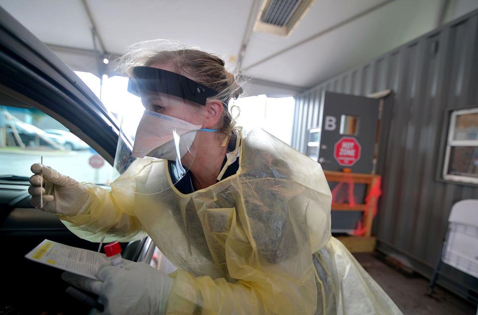 Registered nurse Silvia Petrick administers a COVID-19 test at the drive-thru screening center behind Meritus Medical Plaza on Crayton Boulevard just north of Hagerstown on October 28, 2021.